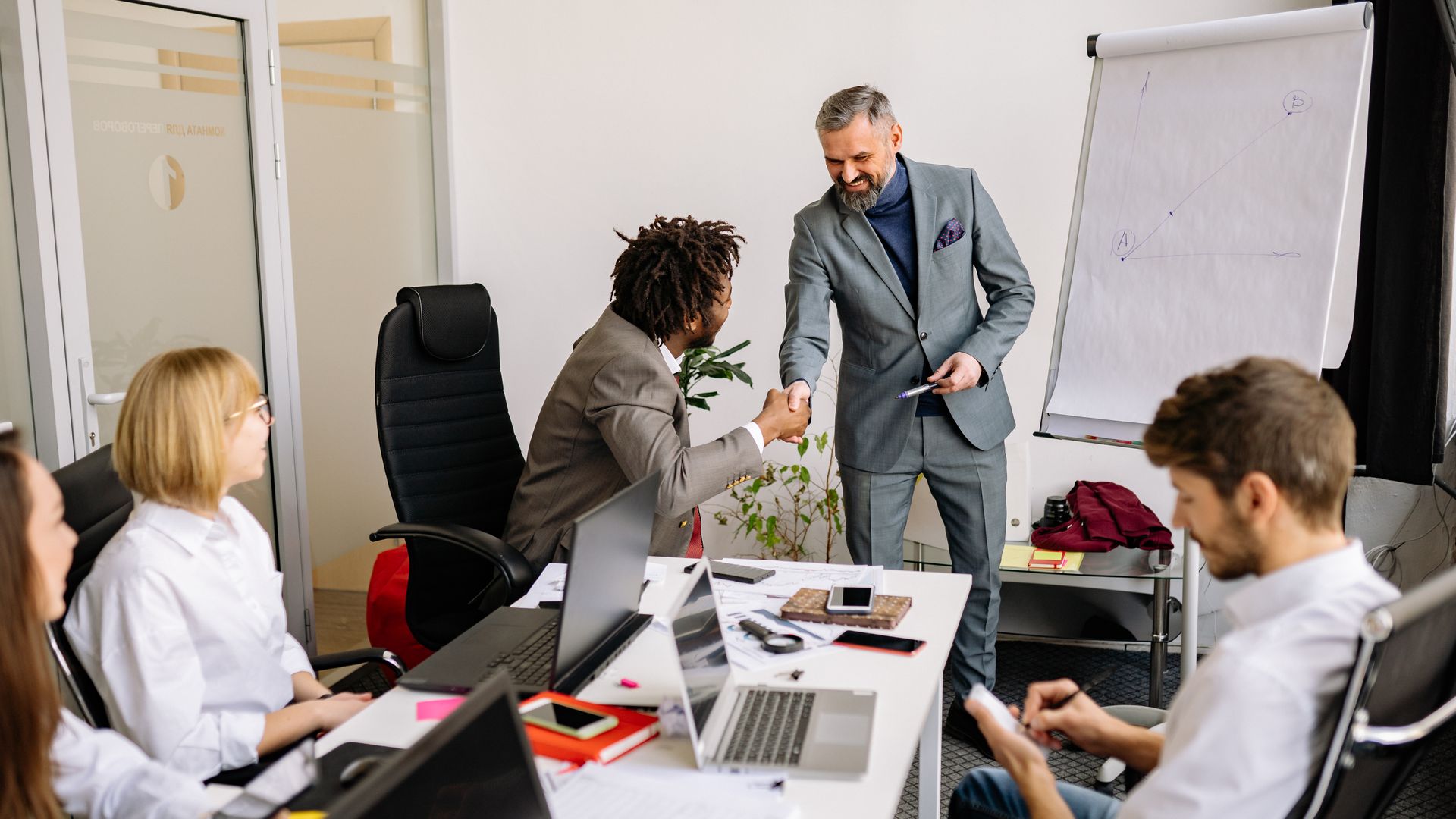 Tax professionals consulting with a business owner in an office